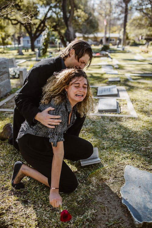 Woman Crying Beside a Man in a Cemetery // Healthier Veterans Today