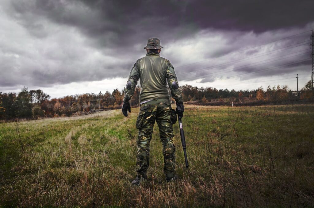 Man in Camouflage Suit Holding Shotgun // Healthier Veterans Today