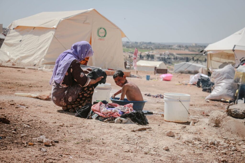 A Mother Washing a Child in a Plastic Tub // Healthier Veterans Today