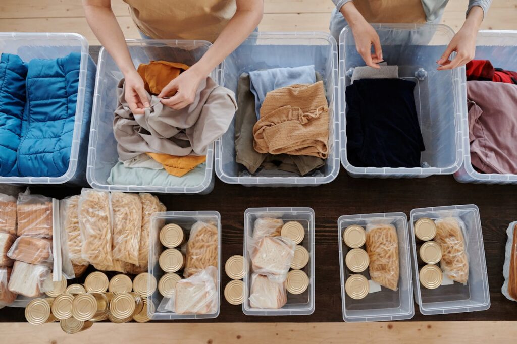 Clothing in Plastic Containers and Food in Cans on Table // Healthier Veterans Today