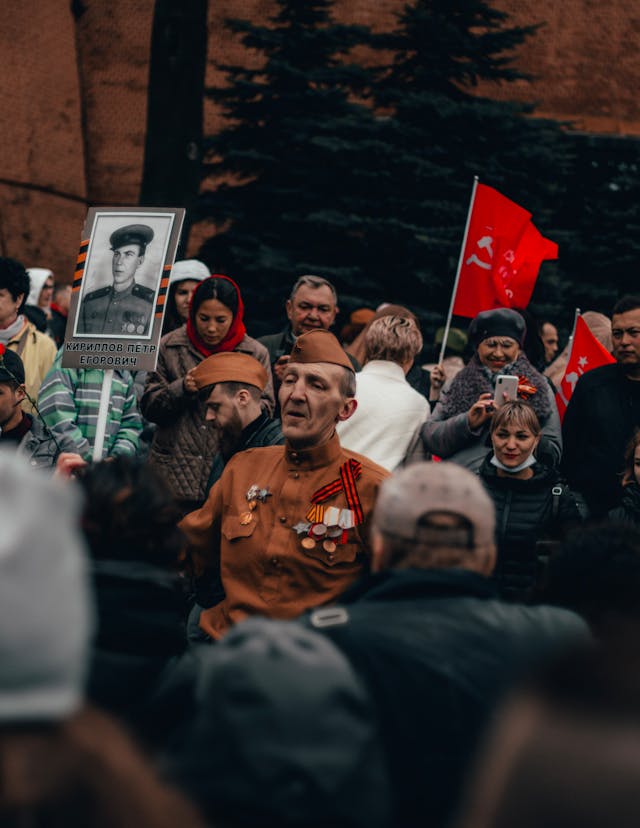 People Standing around Veteran with Medals on Victory Day // Healthier Veterans Today