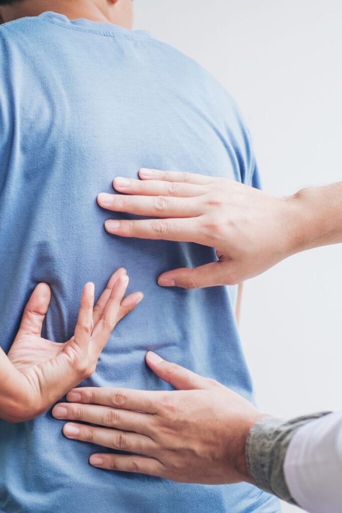 Patients wearing a blue shirt while medical professional examines with hands // Healthier Veterans Today