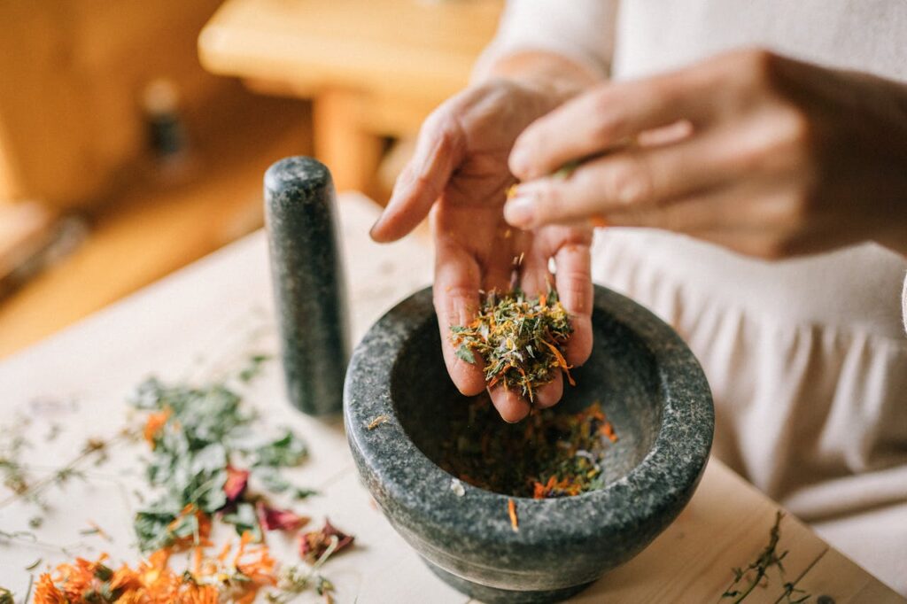 Close-up of Woman Preparing Herbs in Pounder // Healthier Veterans Today