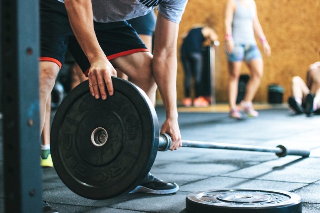 Man adjusting weight plate // Healthier Veterans Today