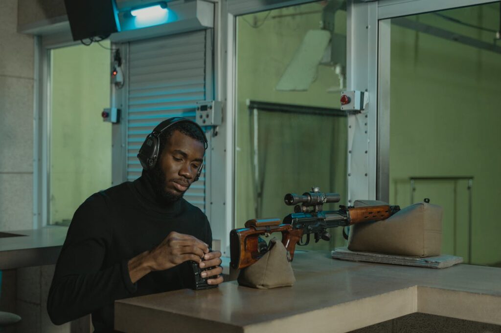 Man in Black Crew Neck Shirt Holding Brown Wooden Rifle // Healthier Veterans Today