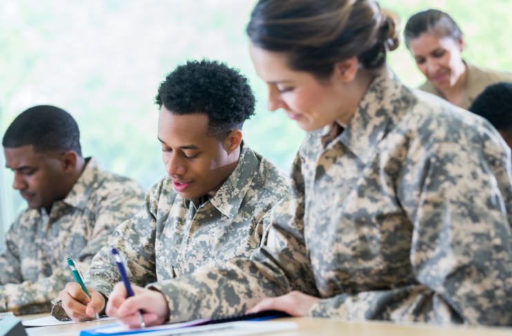 Military service members in uniform completing paperwork and preparing for military service // Healthier Veterans Today